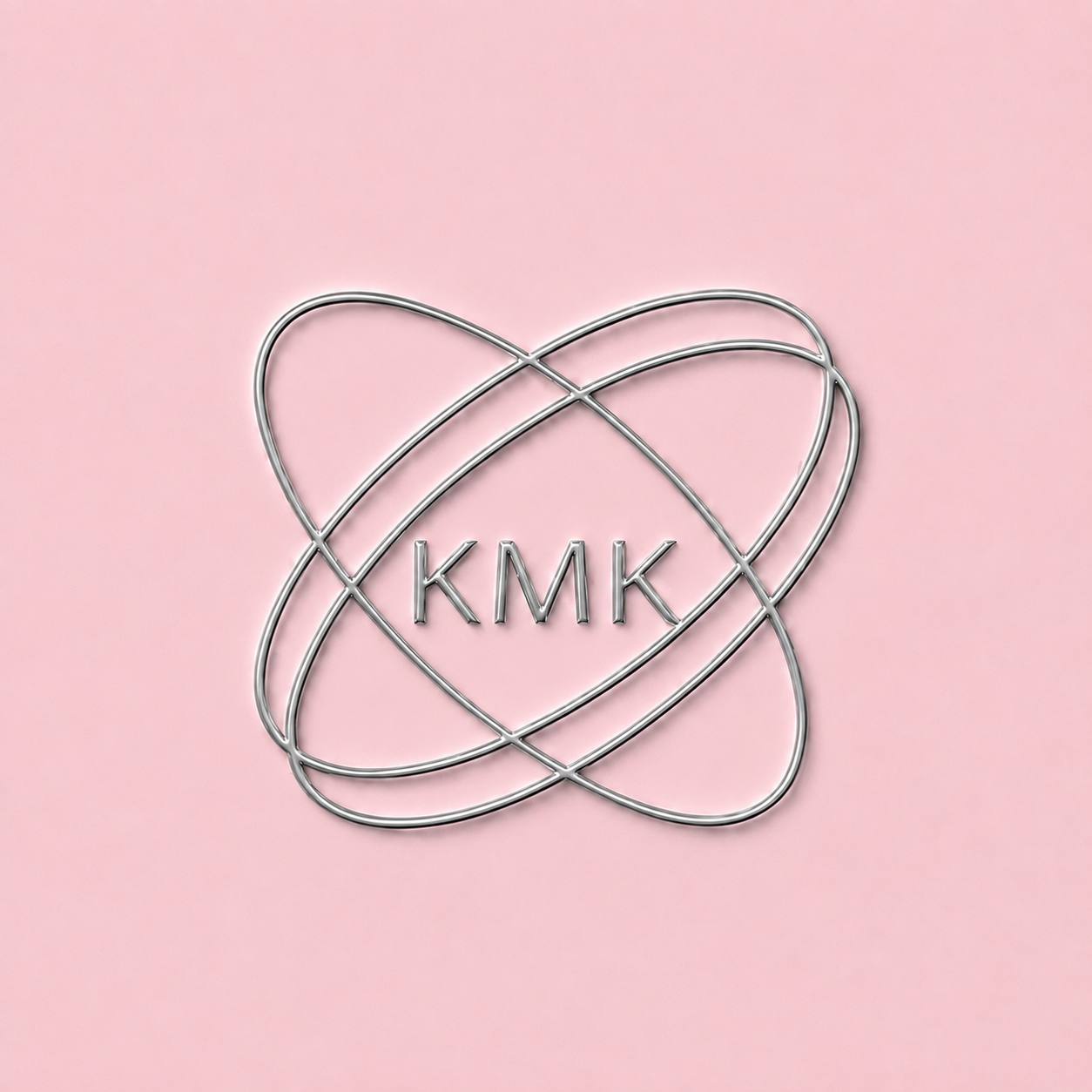 Silver studio emblem on a soft pink background